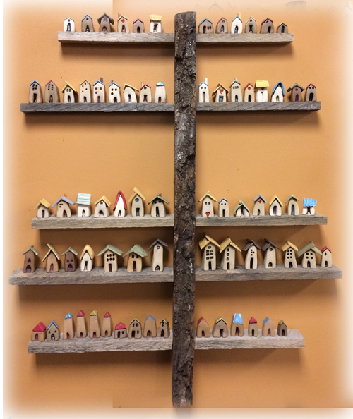 Picture of little bird houses on a tree like shelf